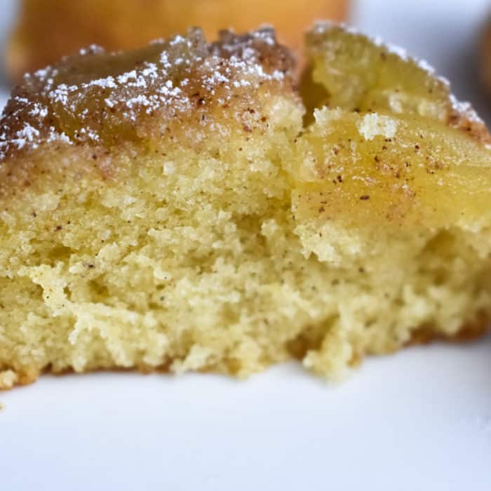 Mini Upside-Down Apple Cake cut in half on a white plate