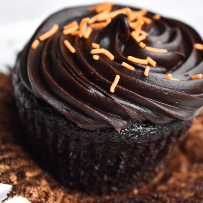 Orange and Dark Chocolate Ganache Cupcakes on a white background